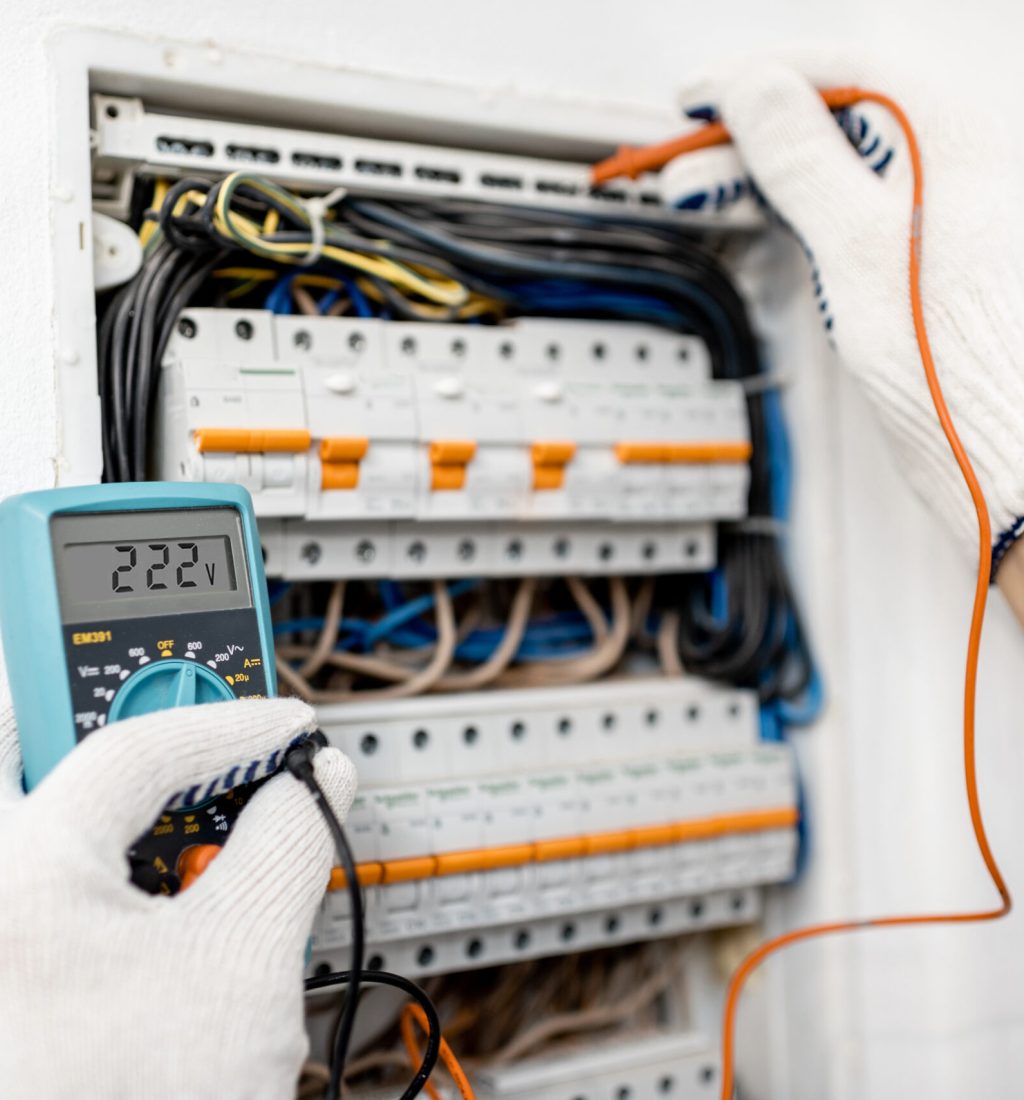 Electrician installing or repairing apartment electrical panel, close-up view